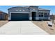 Charming single-story home with gray exterior, well-maintained landscaping, and a two-car garage at 28242 N Nealite Dr, San Tan Valley, AZ 85143