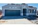 Contemporary home exterior with a gray garage door and stacked roof tiles awaiting install at 28242 N Nealite Dr, San Tan Valley, AZ 85143