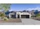 Charming single-story home with desert landscaping and a two-car garage nestled against a backdrop of mountains at 28242 N Nealite Dr, San Tan Valley, AZ 85143