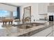 Close-up of kitchen sink and granite countertop, stainless steel appliances, and view to the outdoors at 28242 N Nealite Dr, San Tan Valley, AZ 85143