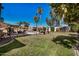 Landscaped backyard featuring a pool, patio furniture, and well-maintained lawn under a clear blue sky at 3036 E Boston St, Gilbert, AZ 85295