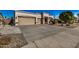 Charming home showcasing a three car garage and low-maintenance desert landscaping at 3036 E Boston St, Gilbert, AZ 85295