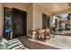 Relaxing front porch showcases chairs, an accent table, and a decorative front door at 3036 E Boston St, Gilbert, AZ 85295