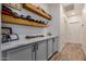 Hallway with custom cabinets, white countertops, and baseball hat decor at 3036 E Boston St, Gilbert, AZ 85295