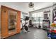 Equipped home gym with sauna, exercise bike, weightlifting equipment, and motivational wall decor at 3036 E Boston St, Gilbert, AZ 85295