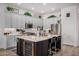 Bright kitchen featuring a kitchen island with seating, wine storage, stainless steel appliances, and light gray cabinets at 3036 E Boston St, Gilbert, AZ 85295