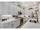 Kitchen with white countertops, stainless steel appliances, mosaic backsplash, and light gray cabinets with decor at 3036 E Boston St, Gilbert, AZ 85295