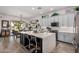 Kitchen island with white countertops and dark cabinets, including barstool seating and stylish decor at 3036 E Boston St, Gilbert, AZ 85295