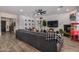 Inviting living room featuring wood-look floors, a sectional sofa and modern decor at 3036 E Boston St, Gilbert, AZ 85295