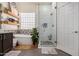 This main bathroom has a stand-alone tub next to a glass-enclosed shower with designer tile at 3036 E Boston St, Gilbert, AZ 85295