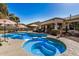 Beautiful pool and spa combo with umbrellas and seating, perfect for outdoor relaxation at 3036 E Boston St, Gilbert, AZ 85295