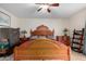 Main bedroom with antique wooden bed frame and ceiling fan at 3125 W Waltann Ln, Phoenix, AZ 85053