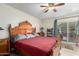 Spacious bedroom with a large wooden bed frame and ceiling fan at 3125 W Waltann Ln, Phoenix, AZ 85053