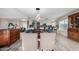 Elegant dining room with a long table, view into kitchen and hardwood floors at 3125 W Waltann Ln, Phoenix, AZ 85053