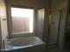 Bathroom with bathtub, shower and large window at 3626 E Thunderhill Pl, Phoenix, AZ 85044