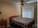 Cozy bedroom with a wood bed frame and geometric quilt at 3626 E Thunderhill Pl, Phoenix, AZ 85044