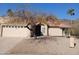 Tan stucco house with tile roof, arched entryway, and mature tree in front at 3626 E Thunderhill Pl, Phoenix, AZ 85044