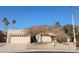 Tan stucco house with tile roof, two-car garage, and desert landscaping at 3626 E Thunderhill Pl, Phoenix, AZ 85044