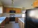 Kitchen with wood cabinets, microwave, stove and island at 3626 E Thunderhill Pl, Phoenix, AZ 85044