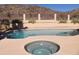 Relaxing kidney-shaped pool with adjacent spa, set against a desert landscape at 3626 E Thunderhill Pl, Phoenix, AZ 85044