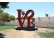 Red LOVE sculpture in a landscaped area at 3928 N Granite Reef Rd, Scottsdale, AZ 85251