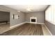 Living room features wood-look flooring, fireplace, and ceiling fan at 3928 N Granite Reef Rd, Scottsdale, AZ 85251