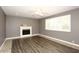 Living room features wood-look flooring, fireplace, and ceiling fan at 3928 N Granite Reef Rd, Scottsdale, AZ 85251