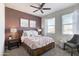 Main bedroom with a wood platform bed, mauve accent wall, and modern nightstands at 5099 E Umber Rd, San Tan Valley, AZ 85143