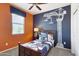 bedroom with a dark wood bed, orange and blue walls, and construction-themed decor at 5099 E Umber Rd, San Tan Valley, AZ 85143