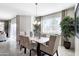 Bright dining room features a light wood table with beige chairs and stylish decor at 5099 E Umber Rd, San Tan Valley, AZ 85143