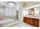 Bathroom with soaking tub, shower, and wooden cabinets at 5635 W Melinda Ln, Glendale, AZ 85308