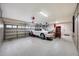 Garage with overhead storage and car lift at 5635 W Melinda Ln, Glendale, AZ 85308