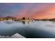 Peaceful lakefront view with a mountain in the background at sunset at 5635 W Melinda Ln, Glendale, AZ 85308