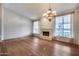 Bright and airy living room with hardwood floors, fireplace, and high ceilings at 5635 W Melinda Ln, Glendale, AZ 85308