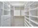 Large walk-in closet with ample shelving and hanging space at 5635 W Melinda Ln, Glendale, AZ 85308