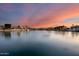 Stunning sunset over calm canal waters with homes along the shore at 5635 W Melinda Ln, Glendale, AZ 85308