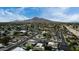 Overhead view of a neighborhood with diverse homes, tree-lined streets, and mountain in the distance at 6331 E Earll Dr, Scottsdale, AZ 85251