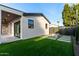 Exterior view of a backyard featuring a paved patio, artificial turf, and a fire pit at 6331 E Earll Dr, Scottsdale, AZ 85251