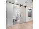 Stylish bathroom featuring a sliding barn door and modern vanity at 6331 E Earll Dr, Scottsdale, AZ 85251