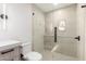 Modern bathroom featuring glass enclosed tiled shower, light fixtures, and floating vanity at 6331 E Earll Dr, Scottsdale, AZ 85251