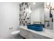 Modern bathroom featuring blue sink and decorative tile wall at 6331 E Earll Dr, Scottsdale, AZ 85251