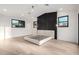 Minimalist bedroom with an accent wall, light wood flooring, and natural light from the windows at 6331 E Earll Dr, Scottsdale, AZ 85251