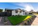 Renovated exterior featuring a stone facade, modern garage, fresh turf, and desert landscaping at 6331 E Earll Dr, Scottsdale, AZ 85251