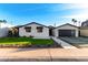 Charming renovated house boasting a stone facade, low-maintenance landscaping, and a modern garage at 6331 E Earll Dr, Scottsdale, AZ 85251