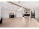 Bright living room featuring a fireplace, built-in bar, modern lighting, and wood-look floors at 6331 E Earll Dr, Scottsdale, AZ 85251