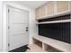 Inviting mud room features built-in bench, storage cabinets, and a sleek black accent wall at 6331 E Earll Dr, Scottsdale, AZ 85251