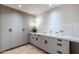 Modern laundry room with ample storage and countertop space at 7153 E Ironwood Dr, Paradise Valley, AZ 85253