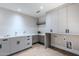 Bright laundry room, custom cabinetry, and hexagon tile floor at 7153 E Ironwood Dr, Paradise Valley, AZ 85253