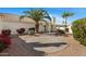 Spacious backyard featuring desert landscaping, palm trees, and a tiled patio at 7390 E Hanover Way, Scottsdale, AZ 85255