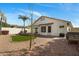 Backyard featuring desert landscaping, a turf lawn, and covered patio at 7390 E Hanover Way, Scottsdale, AZ 85255